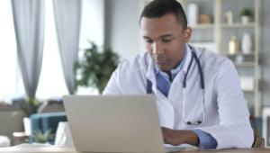 African-American Doctor Working On Laptop